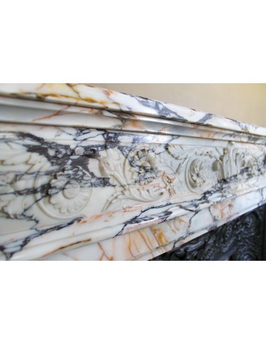 Exceptional antique Neoclassical-style fireplace mantel with fine floral carvings in stunning Italian Calacatta Gold marble.