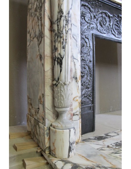 Exceptional antique Neoclassical-style fireplace mantel with fine floral carvings in stunning Italian Calacatta Gold marble.