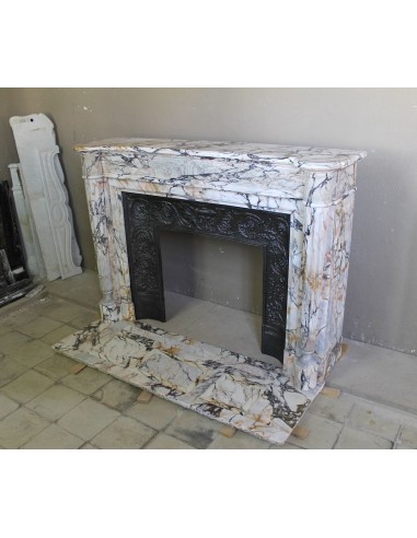 Exceptional antique Neoclassical-style fireplace mantel with fine floral carvings in stunning Italian Calacatta Gold marble.