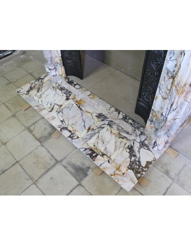 Exceptional antique Neoclassical-style fireplace mantel with fine floral carvings in stunning Italian Calacatta Gold marble.