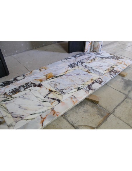 Exceptional antique Neoclassical-style fireplace mantel with fine floral carvings in stunning Italian Calacatta Gold marble.