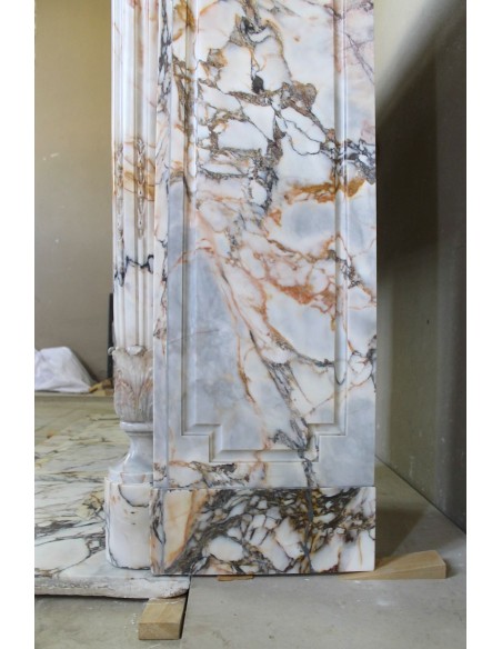 Exceptional antique Neoclassical-style fireplace mantel with fine floral carvings in stunning Italian Calacatta Gold marble.