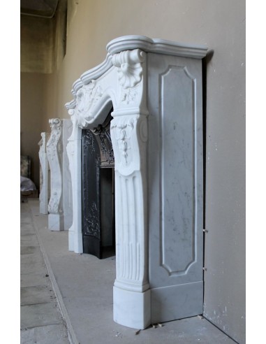 Antique Louis XV "Rosaces" fireplace mantel carved in top-quality White Carrara marble, extremely pure and refined.