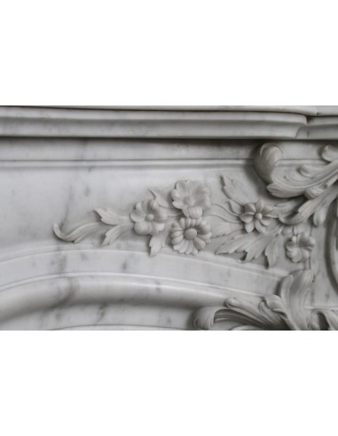 Antique Baroque white marble fire surround with exquisitely refined floral carvings, with its original cast iron insert.