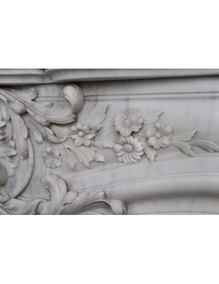 Antique Baroque white marble fire surround with exquisitely refined floral carvings, with its original cast iron insert.