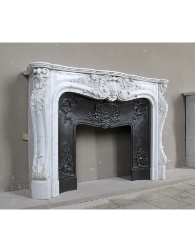 Antique Baroque white marble fire surround with exquisitely refined floral carvings, with its original cast iron insert.