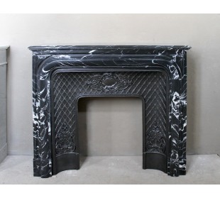 Antique "Boudin Arrondi" fireplace mantel in Black Marquinia veined marble provided with its original cast iron insert.