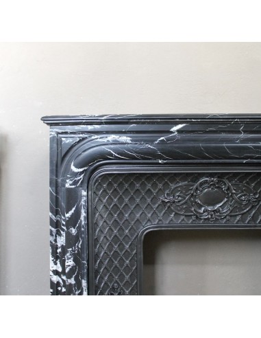 Antique "Boudin Arrondi" fireplace mantel in Black Marquinia veined marble provided with its original cast iron insert.