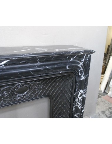 Antique "Boudin Arrondi" fireplace mantel in Black Marquinia veined marble provided with its original cast iron insert.