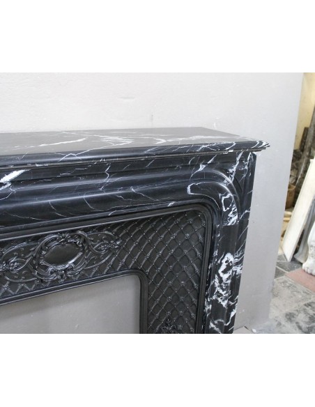Antique "Boudin Arrondi" fireplace mantel in Black Marquinia veined marble provided with its original cast iron insert.