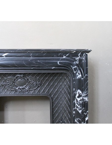 Antique "Boudin Arrondi" fireplace mantel in Black Marquinia veined marble provided with its original cast iron insert.