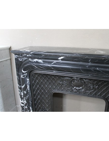 Antique "Boudin Arrondi" fireplace mantel in Black Marquinia veined marble provided with its original cast iron insert.