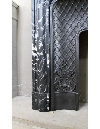 Antique "Boudin Arrondi" fireplace mantel in Black Marquinia veined marble provided with its original cast iron insert.