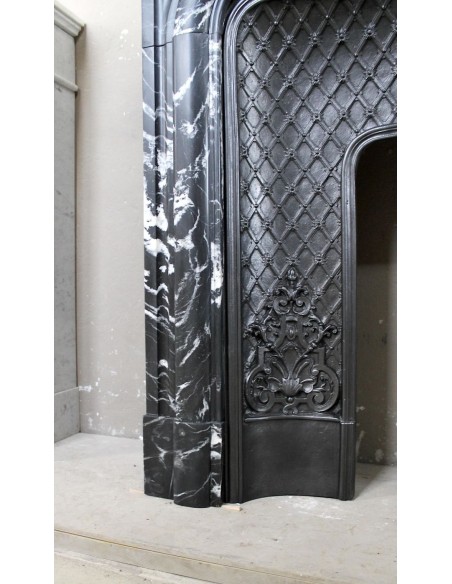 Antique "Boudin Arrondi" fireplace mantel in Black Marquinia veined marble provided with its original cast iron insert.