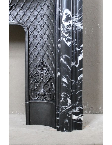 Antique "Boudin Arrondi" fireplace mantel in Black Marquinia veined marble provided with its original cast iron insert.