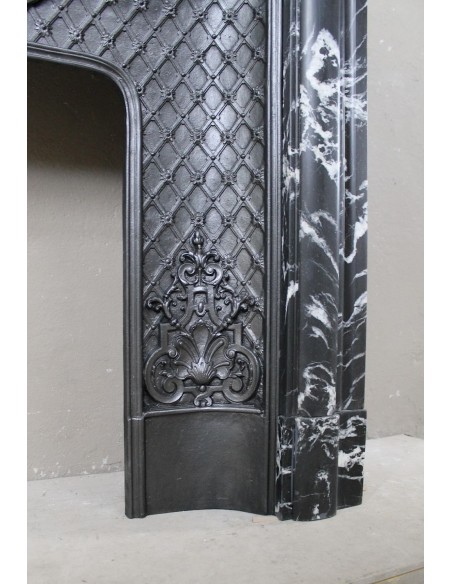 Antique "Boudin Arrondi" fireplace mantel in Black Marquinia veined marble provided with its original cast iron insert.