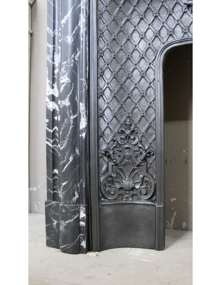 Antique "Boudin Arrondi" fireplace mantel in Black Marquinia veined marble provided with its original cast iron insert.