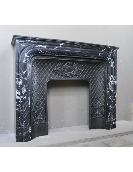Antique "Boudin Arrondi" fireplace mantel in Black Marquinia veined marble provided with its original cast iron insert.