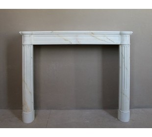 Antique neoclassical marble fireplace mantel with golden veins on a white background. A truly elegant marble fire surround.