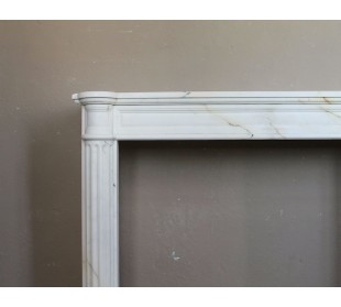 Antique neoclassical marble fireplace mantel with golden veins on a white background. A truly elegant marble fire surround. 2