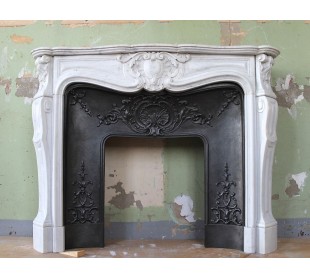 Louis XV “Moustache” fireplace mantel in White Carrara marble and fitted with its original cast iron insert.