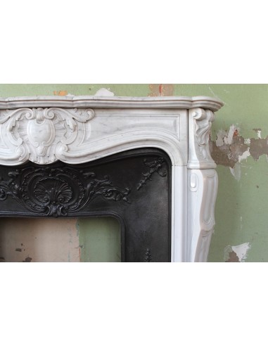 Louis XV “Moustache” fireplace mantel in White Carrara marble and fitted with its original cast iron insert.