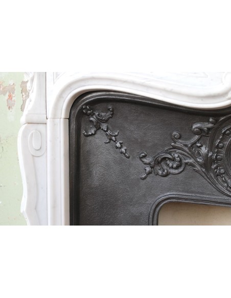 Louis XV “Moustache” fireplace mantel in White Carrara marble and fitted with its original cast iron insert.