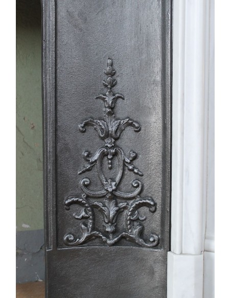 Louis XV “Moustache” fireplace mantel in White Carrara marble and fitted with its original cast iron insert.
