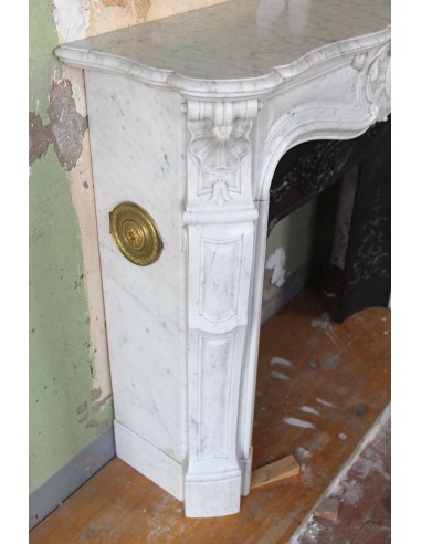 Louis XV “Moustache” fireplace mantel in White Carrara marble and fitted with its original cast iron insert.