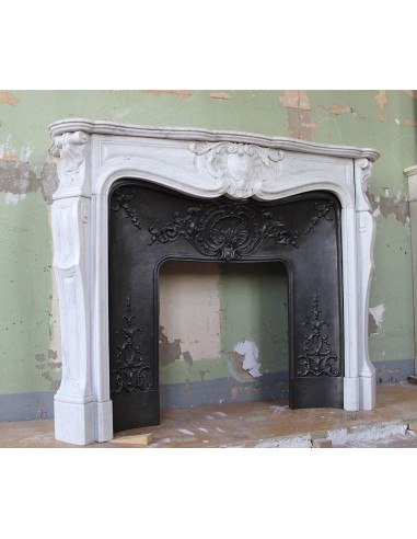 Louis XV “Moustache” fireplace mantel in White Carrara marble and fitted with its original cast iron insert.