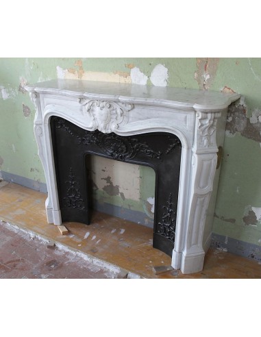 Louis XV “Moustache” fireplace mantel in White Carrara marble and fitted with its original cast iron insert.