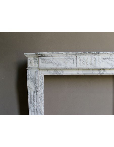 Antique neoclassical fireplace mantel carved in White veined Arabescato marble. This marble surround has exquisite veining.
