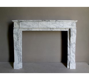 Antique neoclassical fireplace mantel carved in White veined Arabescato marble. This marble surround has exquisite veining.
