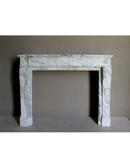 Antique neoclassical fireplace mantel carved in White veined Arabescato marble. This marble surround has exquisite veining.