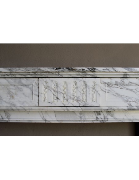 Antique neoclassical fireplace mantel carved in White veined Arabescato marble. This marble surround has exquisite veining.