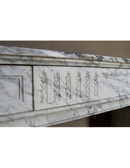 Antique neoclassical fireplace mantel carved in White veined Arabescato marble. This marble surround has exquisite veining.