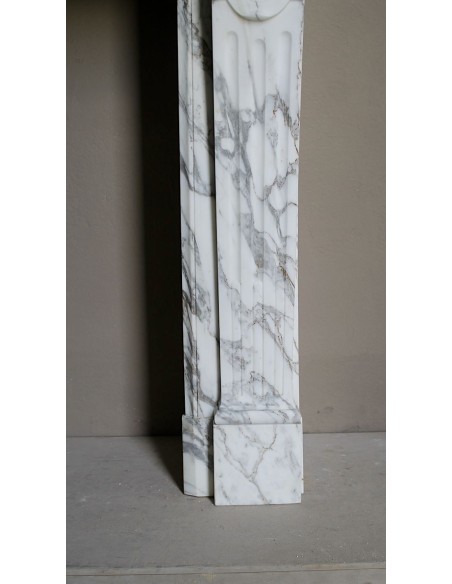 Antique neoclassical fireplace mantel carved in White veined Arabescato marble. This marble surround has exquisite veining.