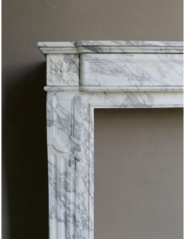 Antique neoclassical fireplace mantel carved in White veined Arabescato marble. This marble surround has exquisite veining.