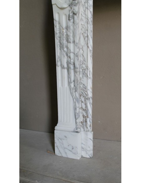 Antique neoclassical fireplace mantel carved in White veined Arabescato marble. This marble surround has exquisite veining.