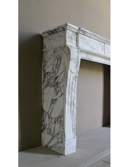 Antique neoclassical fireplace mantel carved in White veined Arabescato marble. This marble surround has exquisite veining.