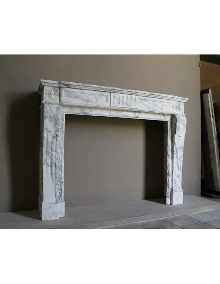 Antique neoclassical fireplace mantel carved in White veined Arabescato marble. This marble surround has exquisite veining.