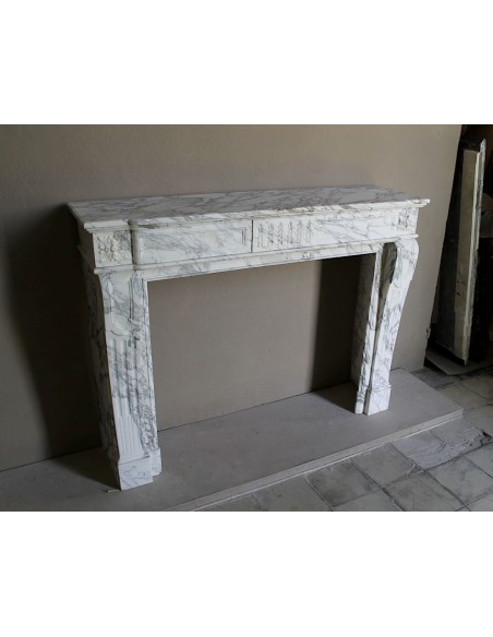 Antique neoclassical fireplace mantel carved in White veined Arabescato marble. This marble surround has exquisite veining.