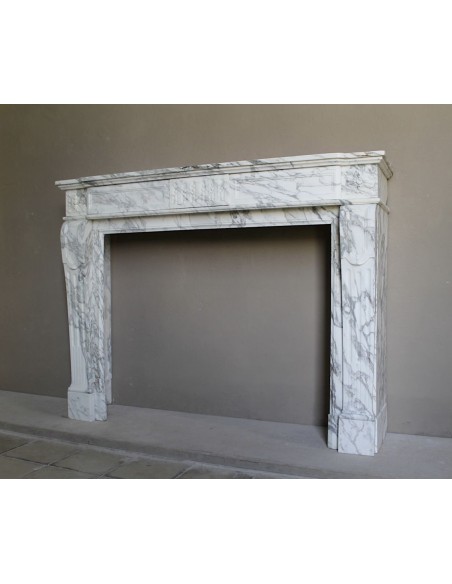 Antique neoclassical fireplace mantel carved in White veined Arabescato marble. This marble surround has exquisite veining.