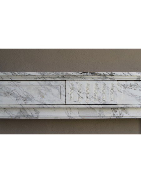 Antique neoclassical fireplace mantel carved in White veined Arabescato marble. This marble surround has exquisite veining.