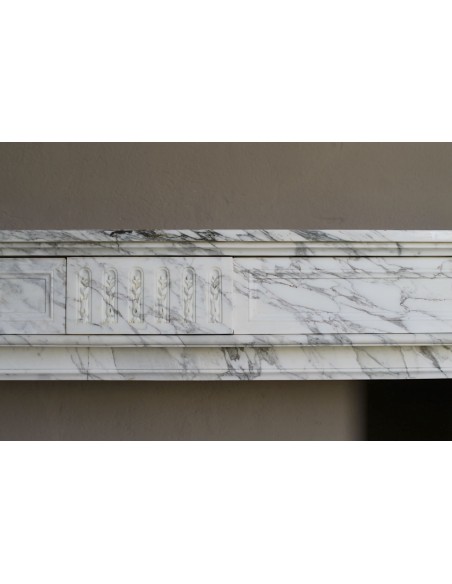 Antique neoclassical fireplace mantel carved in White veined Arabescato marble. This marble surround has exquisite veining.