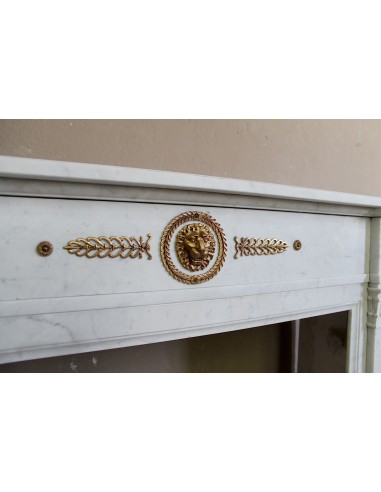 Antique neoclassical mantel carved in White marble with gilded bronzes depicting olive leaves and lions.