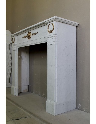 Antique neoclassical mantel carved in White marble with gilded bronzes depicting olive leaves and lions.