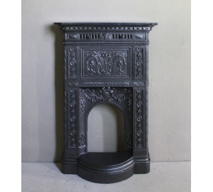 Antique “Larcher” cast iron mantelpiece with floral decorations. A refined, elegant, 19th-century antique fire surround.