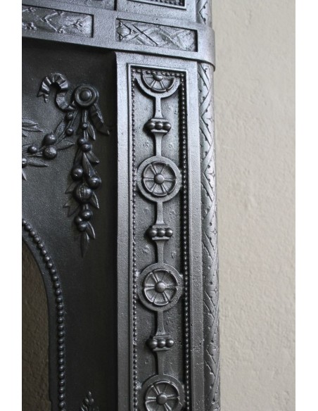 Antique “Larcher” cast iron mantelpiece with floral decorations. A refined, elegant, 19th-century antique fire surround.