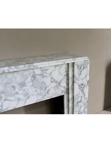 Antique iconic Art Deco mantelpiece carved in white veined Arabescato marble with Portoro marble inserts.